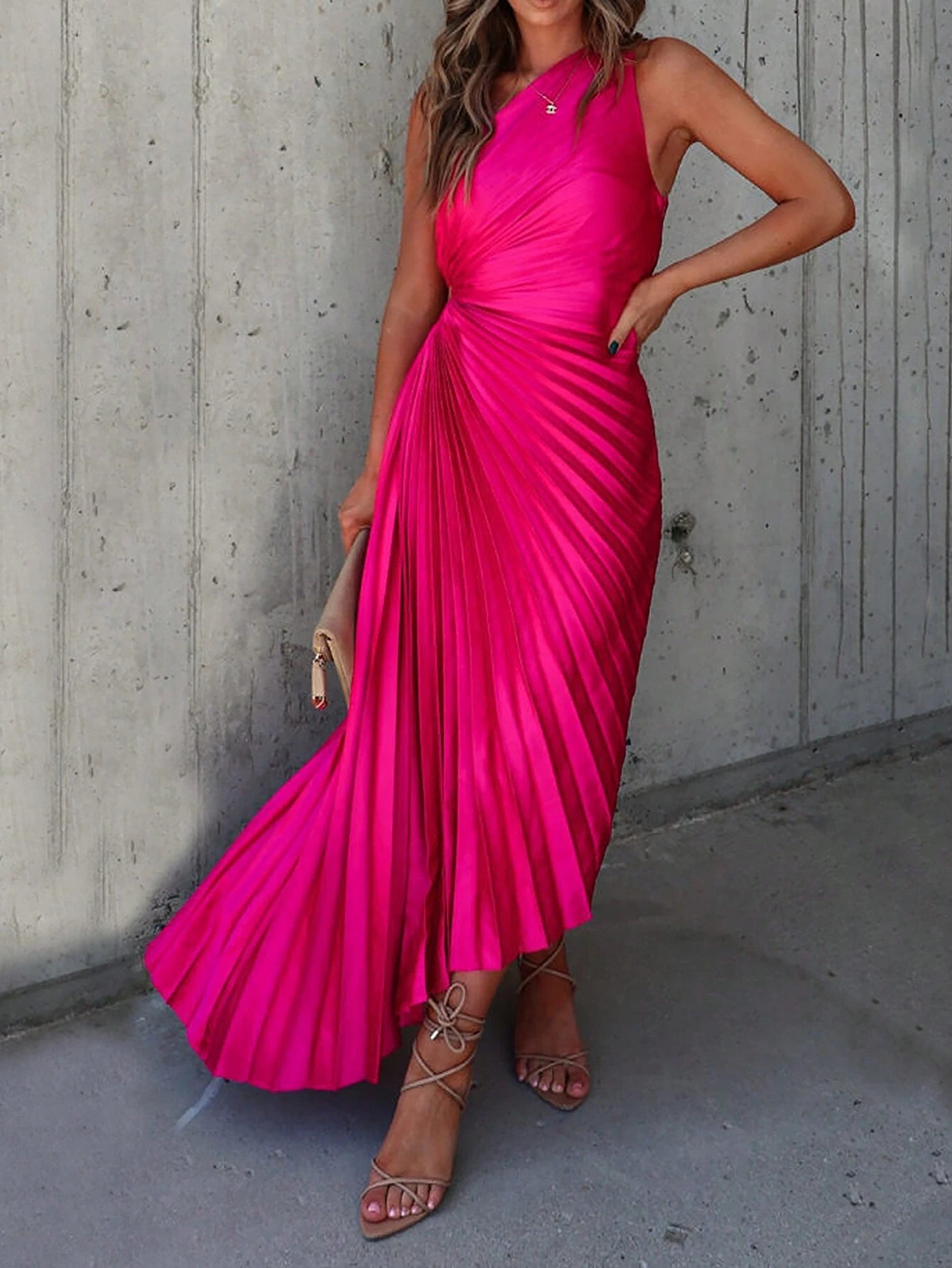 	Une robe cocktail satin de couleur fuchsia avec des plis élégants, présentée de face. La robe est sans manches et présente une coupe asymétrique avec une ouverture sur le côté de la taille.